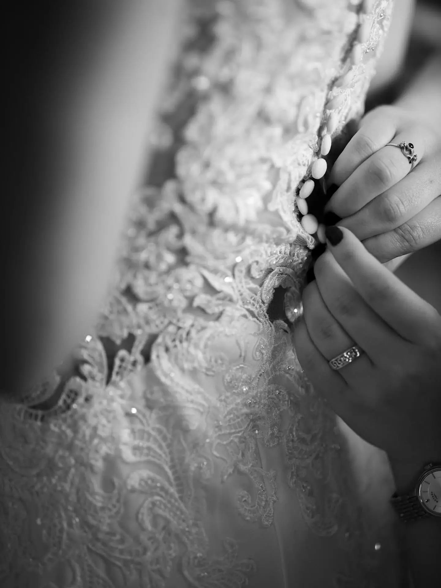 A brides wedding dress getting fastened